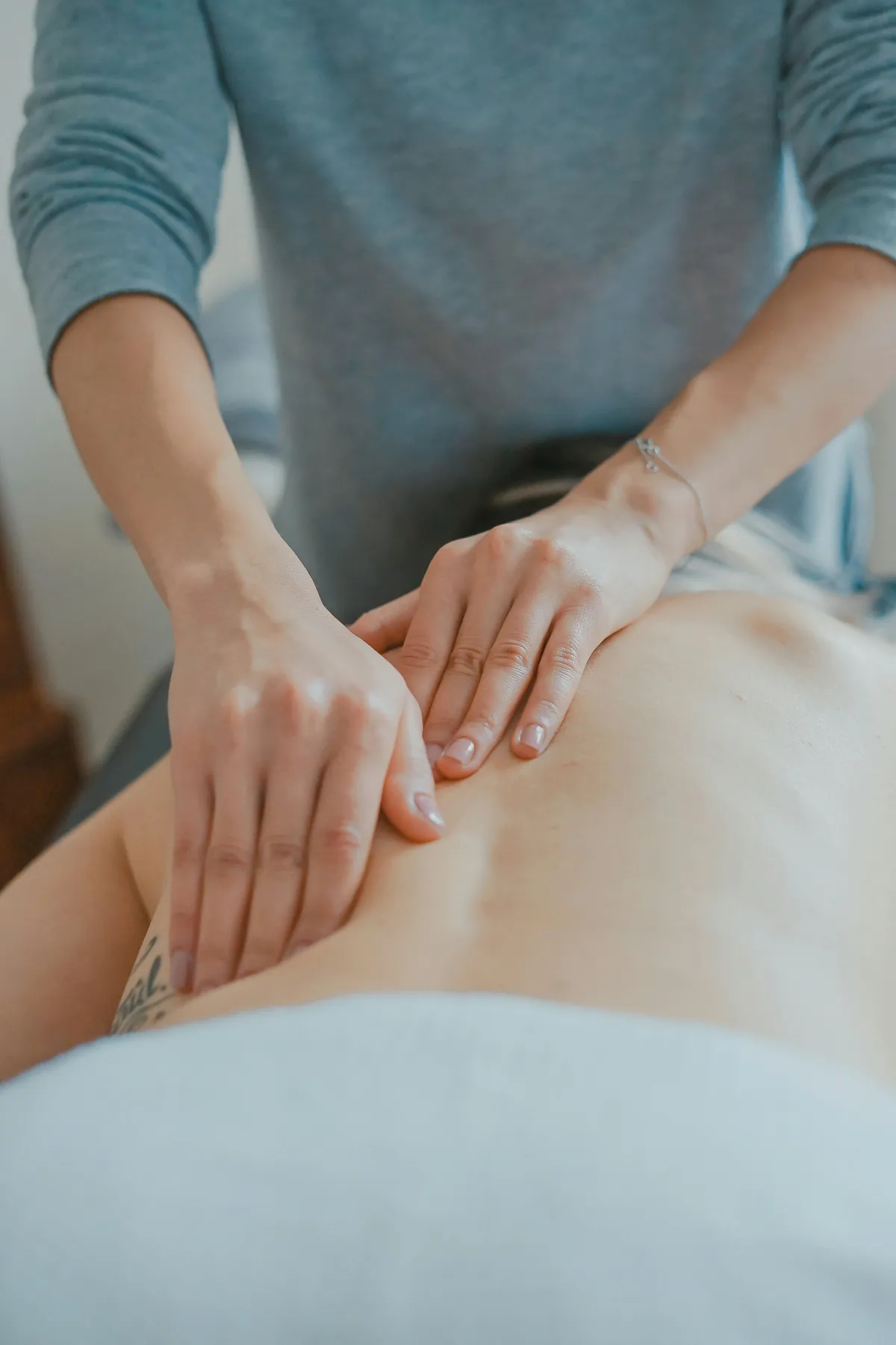 Hands providing therapeutic back massage