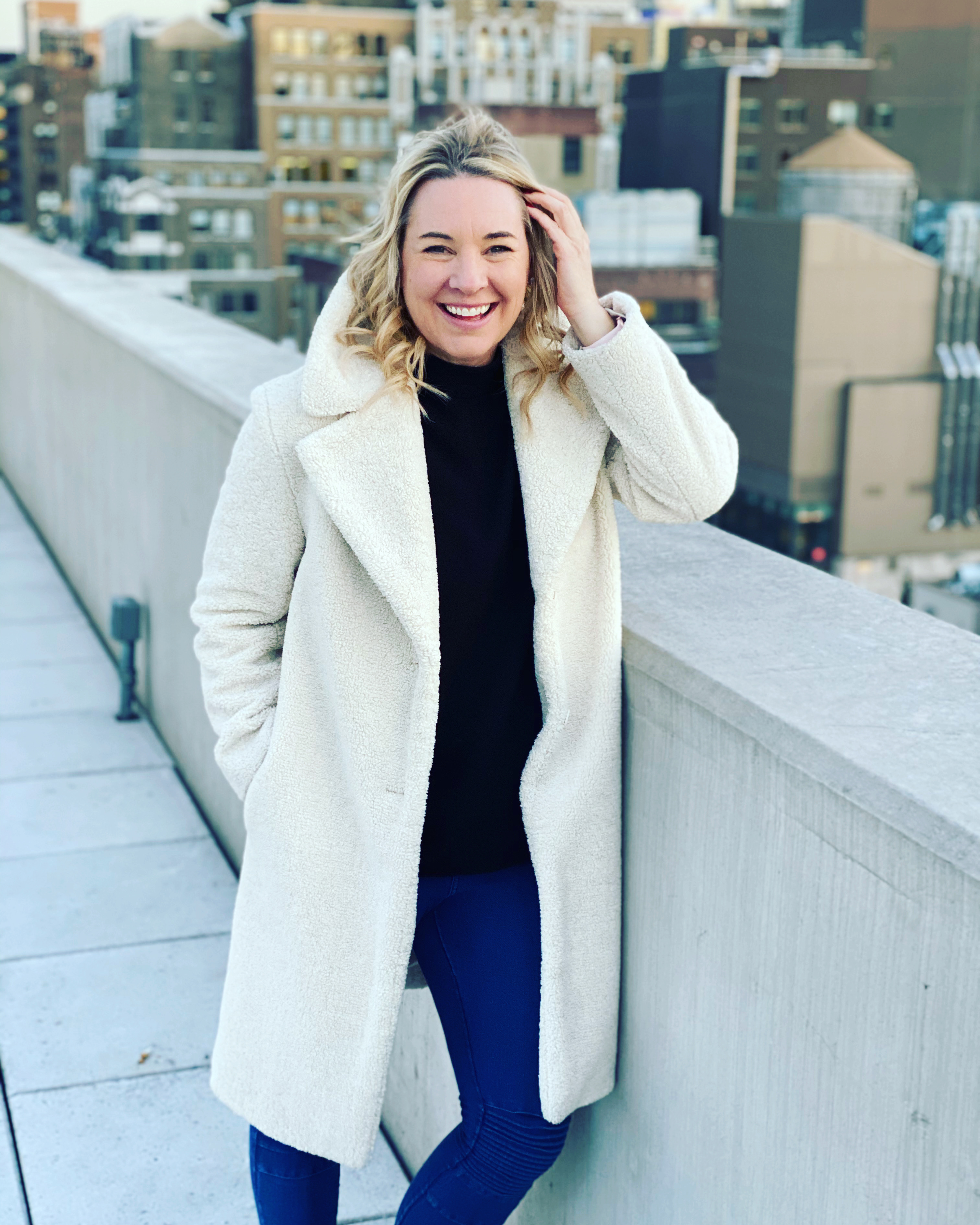 a bedroom with a bed, desk, and a window