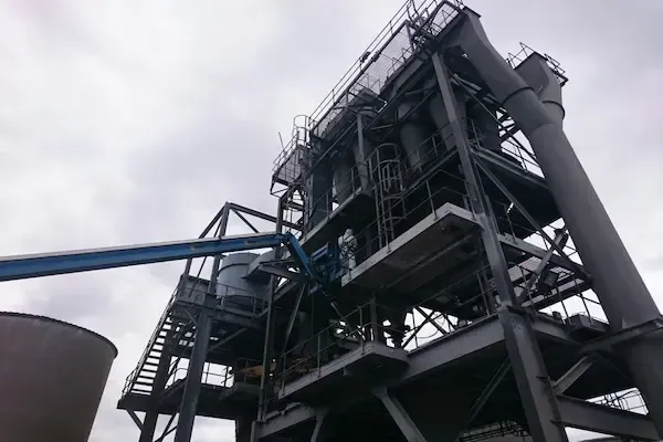 Industrial oil and gas processing pipework under an overcast sky