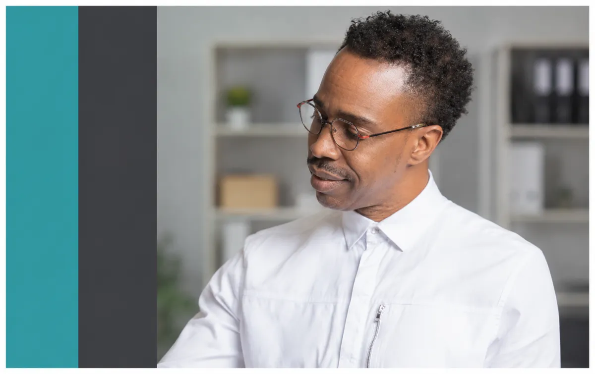 Founder of Cross Point Solutions in a professional office during retirement and financial planning consultation work