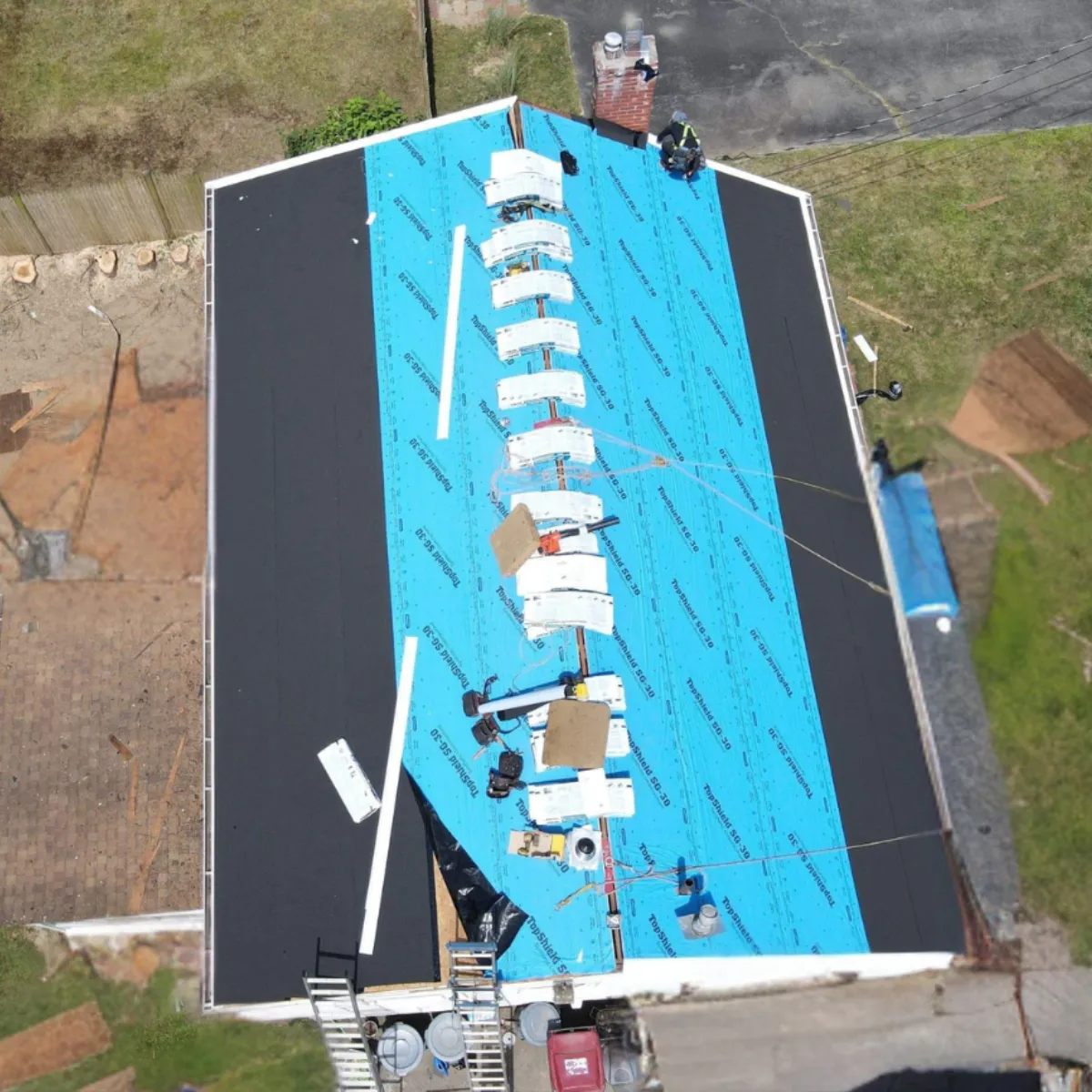 roof replacement Melrose MA asphalt shingle installation process on residential home aerial view