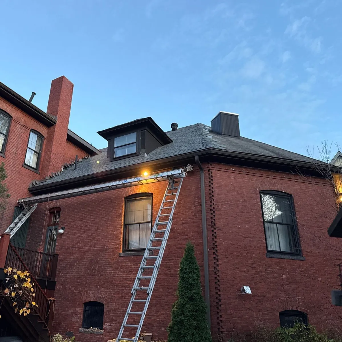 Roof replacement work in progress on historic brick home in Malden MA