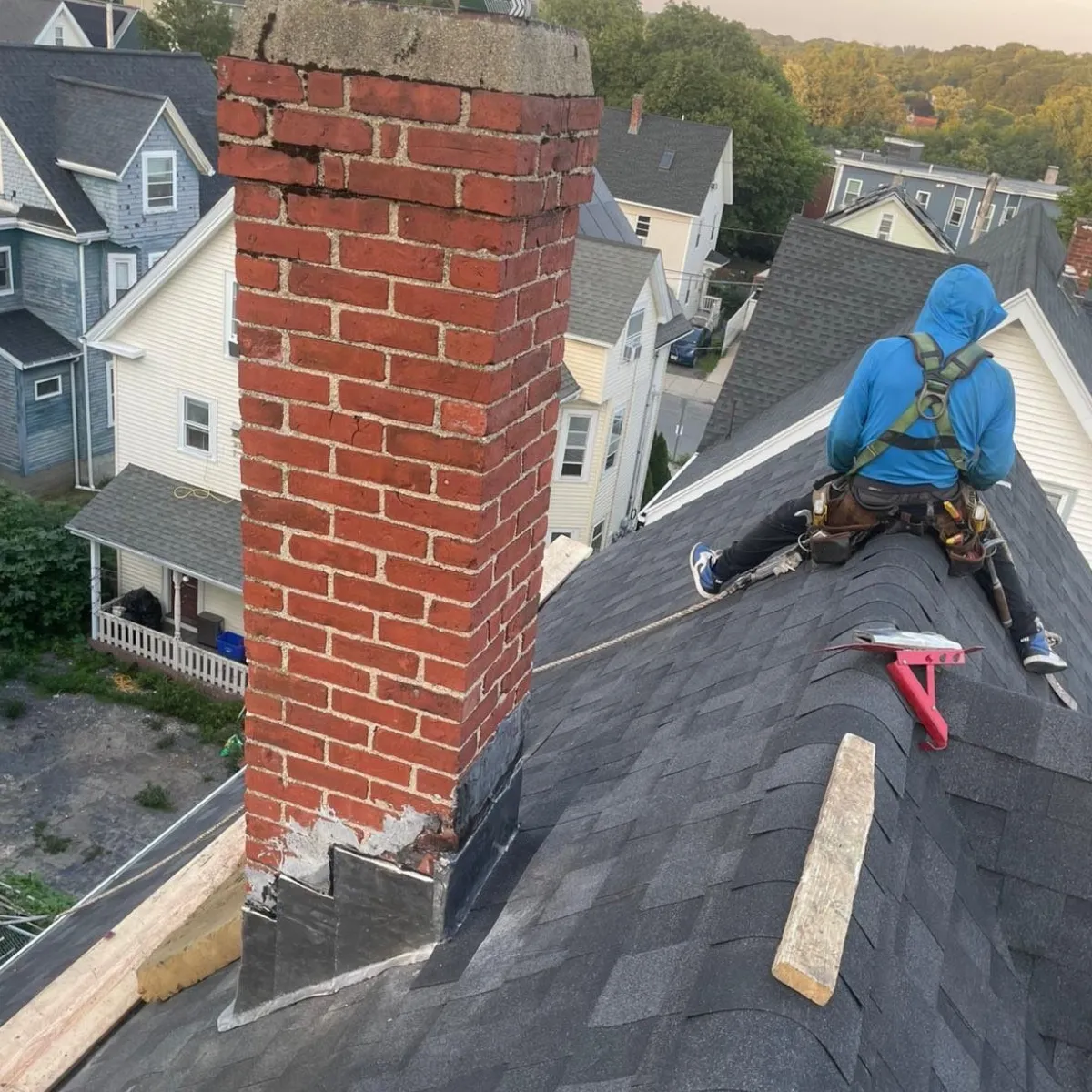 roof repair Melrose MA contractor replacing damaged asphalt shingles on residential roof slope
