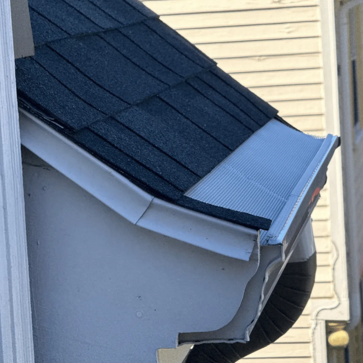 Gutter repair with guard system installed on residential roof in Wakefield MA