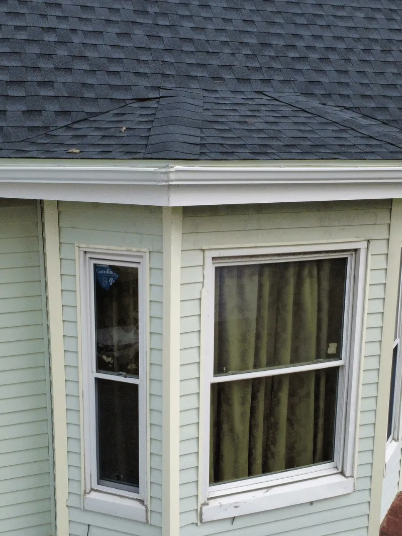 Roof replacement work in progress on historic brick home in Malden MA