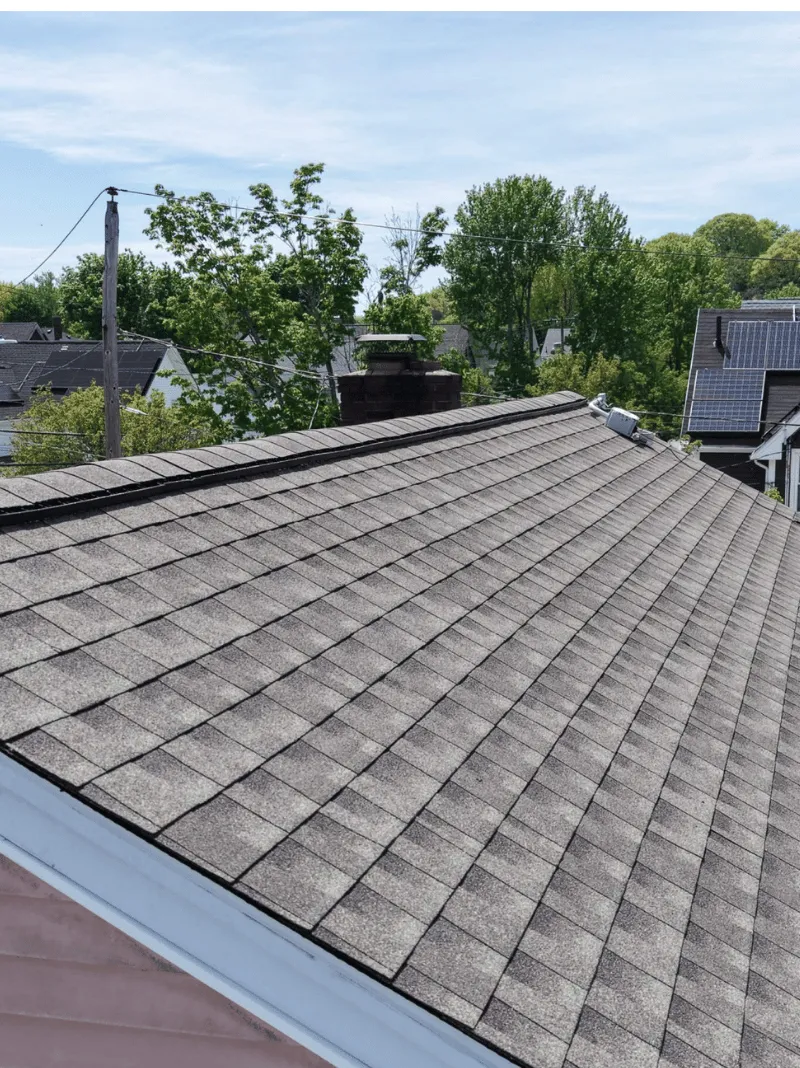 Roof replacement work in progress on historic brick home in Malden MA