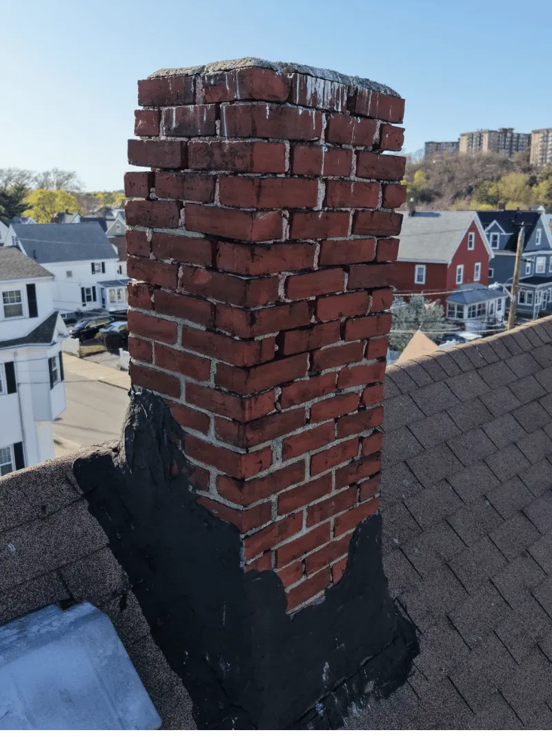 Roof replacement work in progress on historic brick home in Malden MA