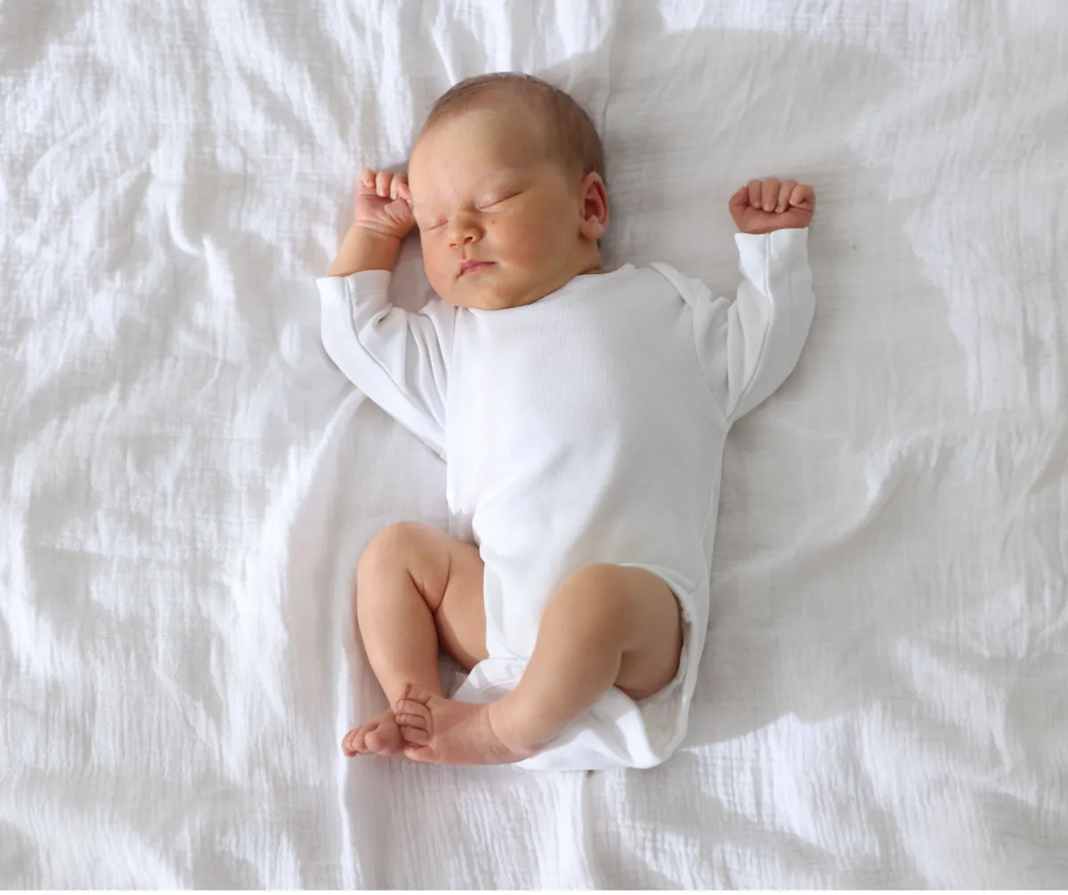 Sleeping baby supported by an infant sleep consultant in Australia offering in home and virtual sleep support