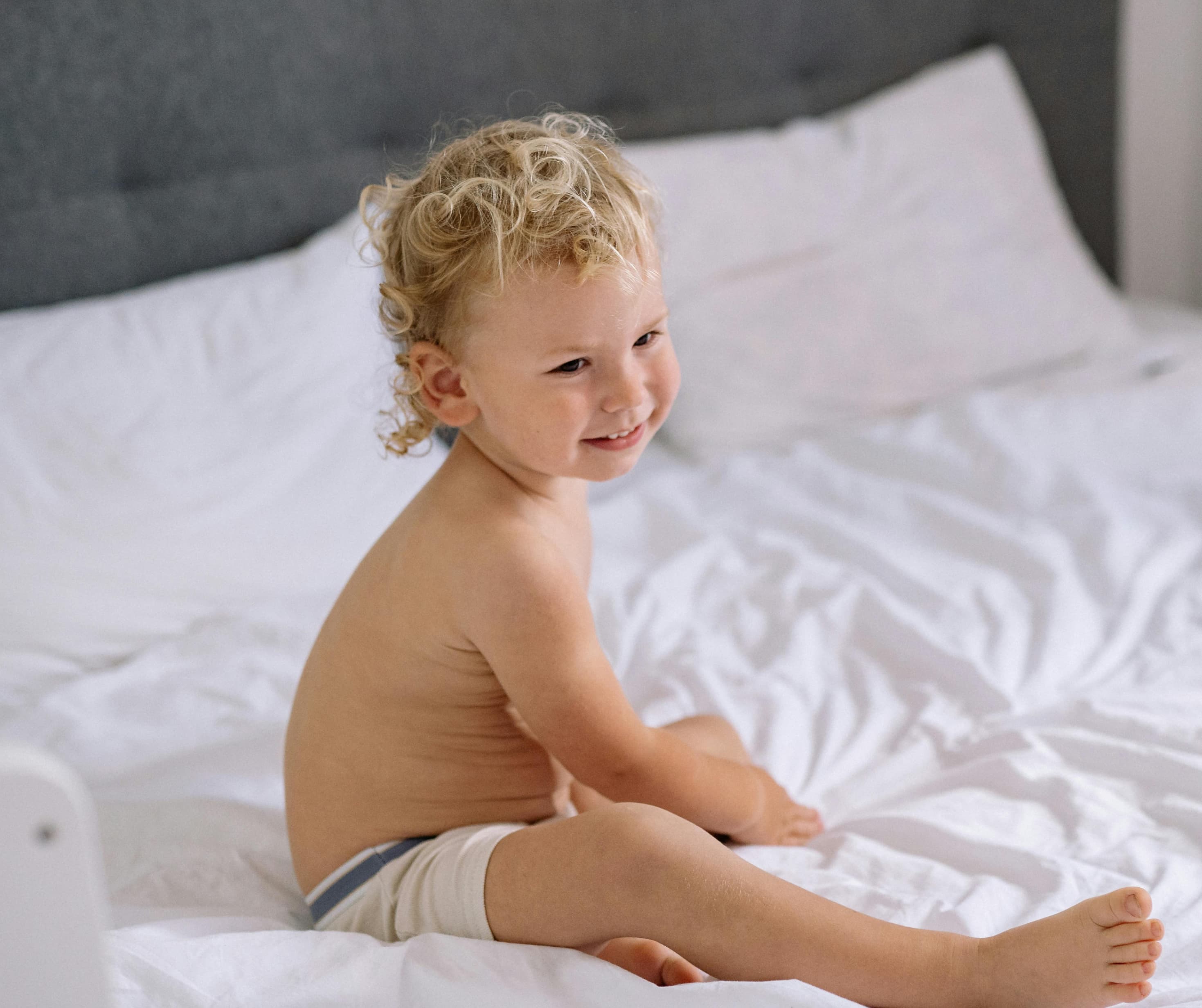 Toddler sleeping with comforter as part of a toddler sleep training program for ages 2 to 4 years