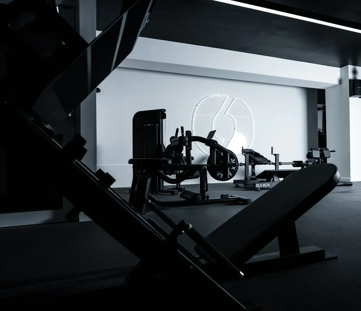 Interior of MARCHON Bath gym with bold wall branding and strength training equipment
