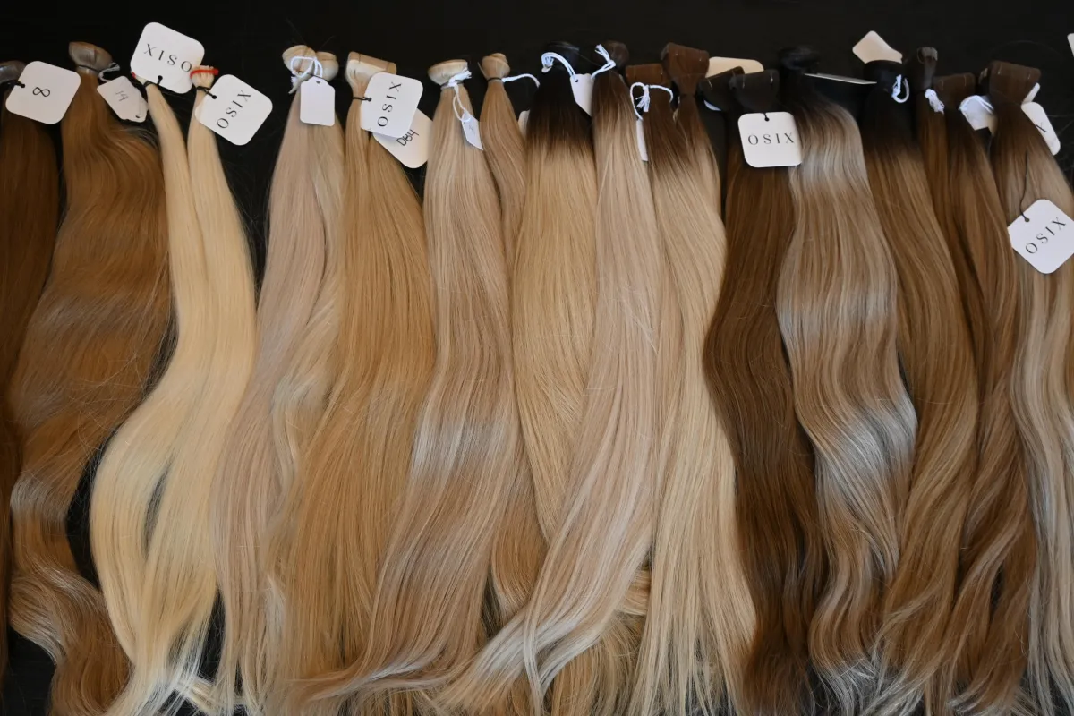 woman in white shirt standing near black leather chairs