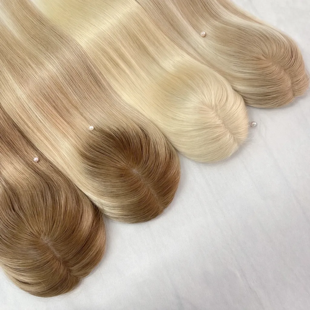woman in white shirt standing near black leather chairs