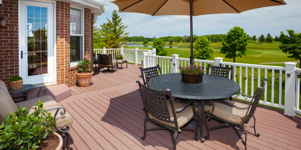 Custom backyard deck with patio furniture and umbrella for outdoor living