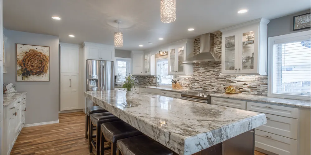 Modern kitchen remodel with white cabinets, granite countertops, and stainless steel appliances