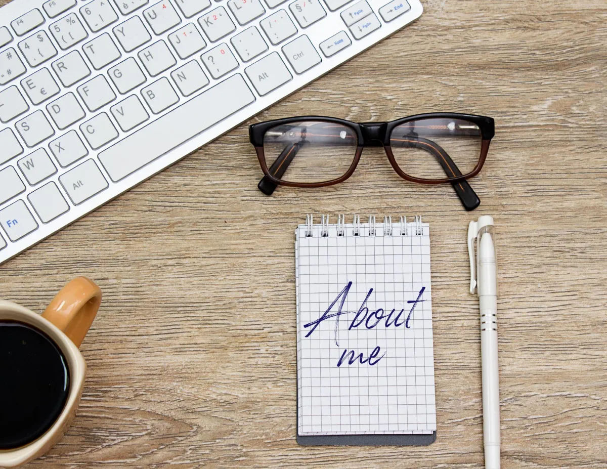 About Me with glasses and pen