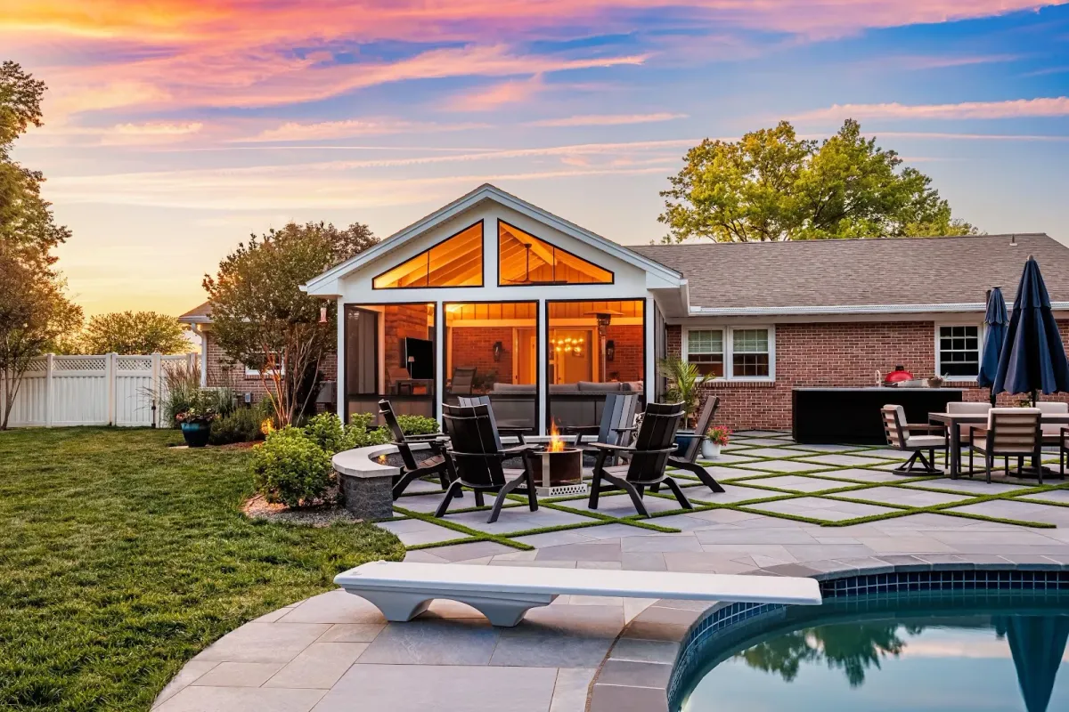A modern backyard patio with pool and fire pit created by a landscaper in Bridgeport, PA.