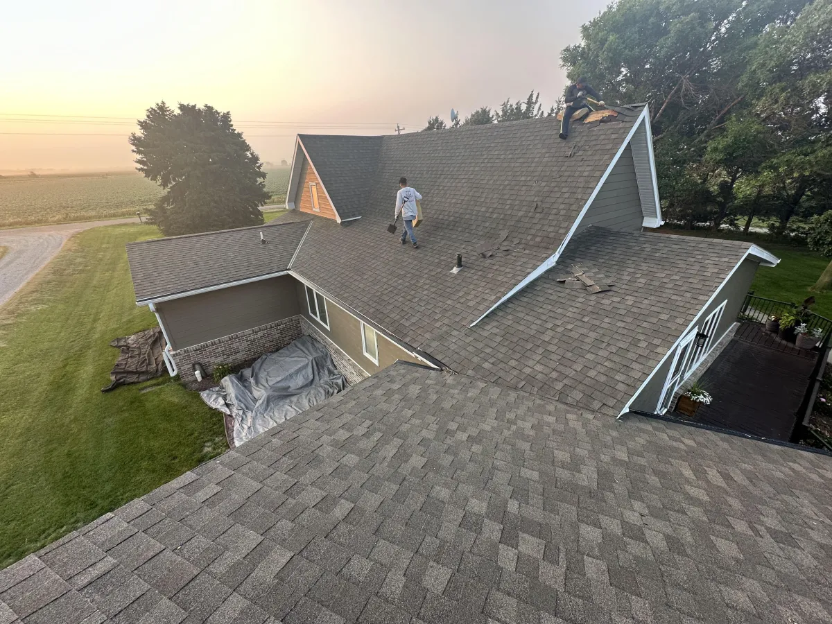 an expert roofer working on shingle roofing