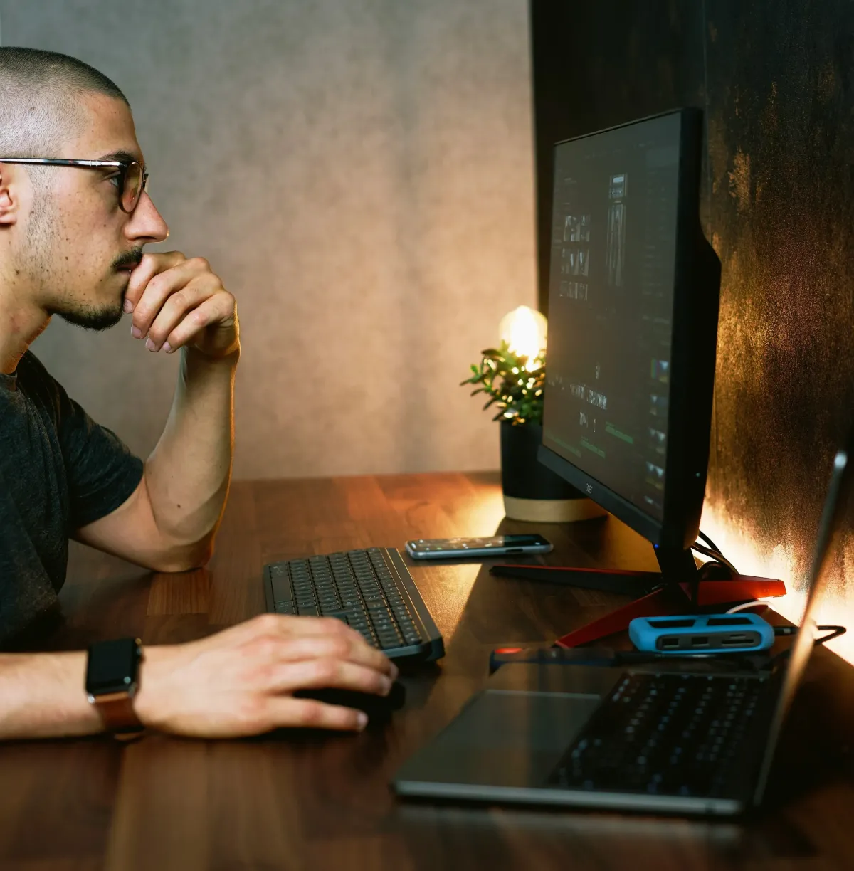 Web developer coding a custom website on dual monitors