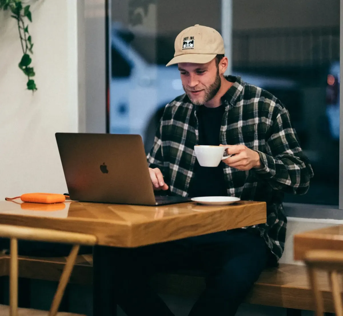 	Business owner responding to enquiries on laptop in cafe