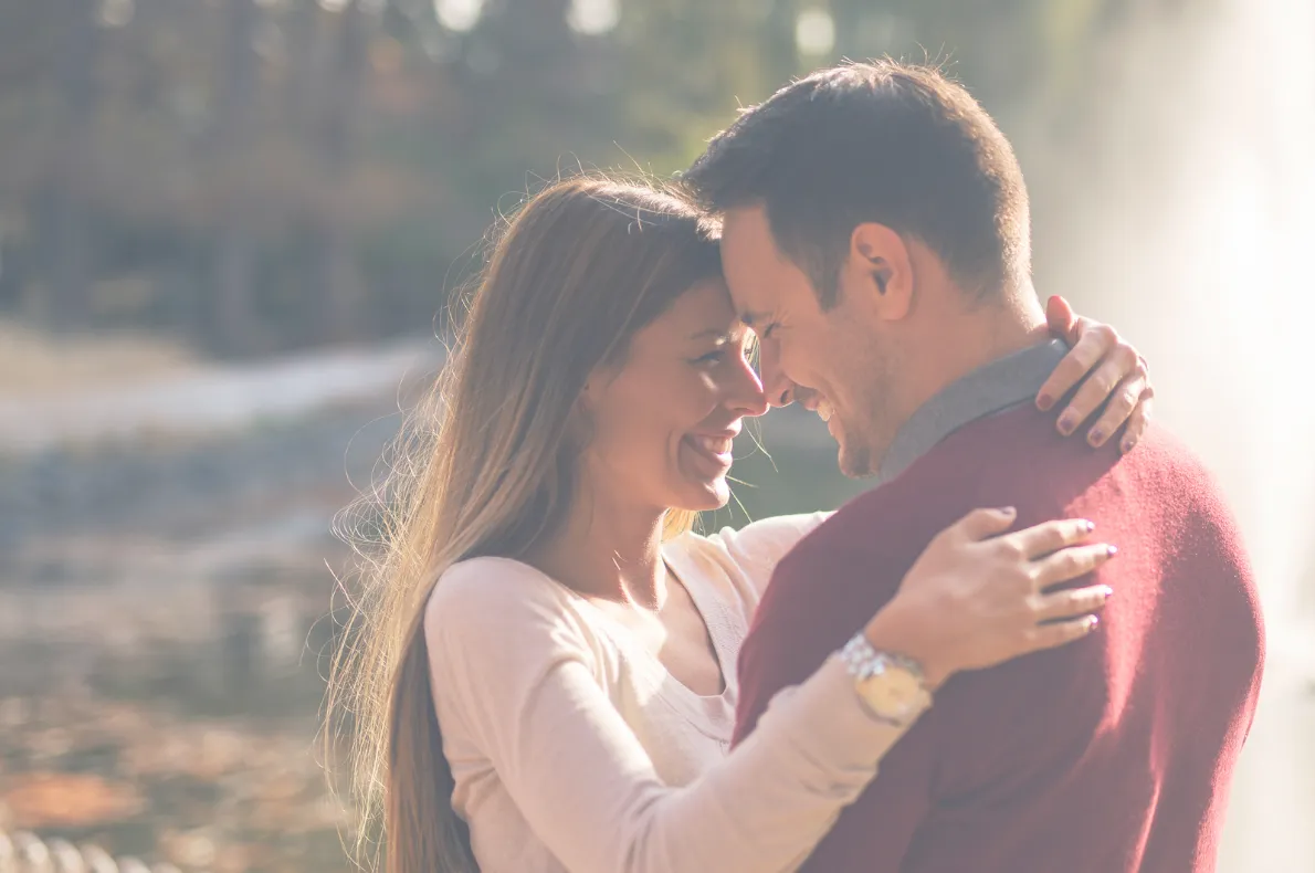 brown grass field near mountain under blue sky during daytime