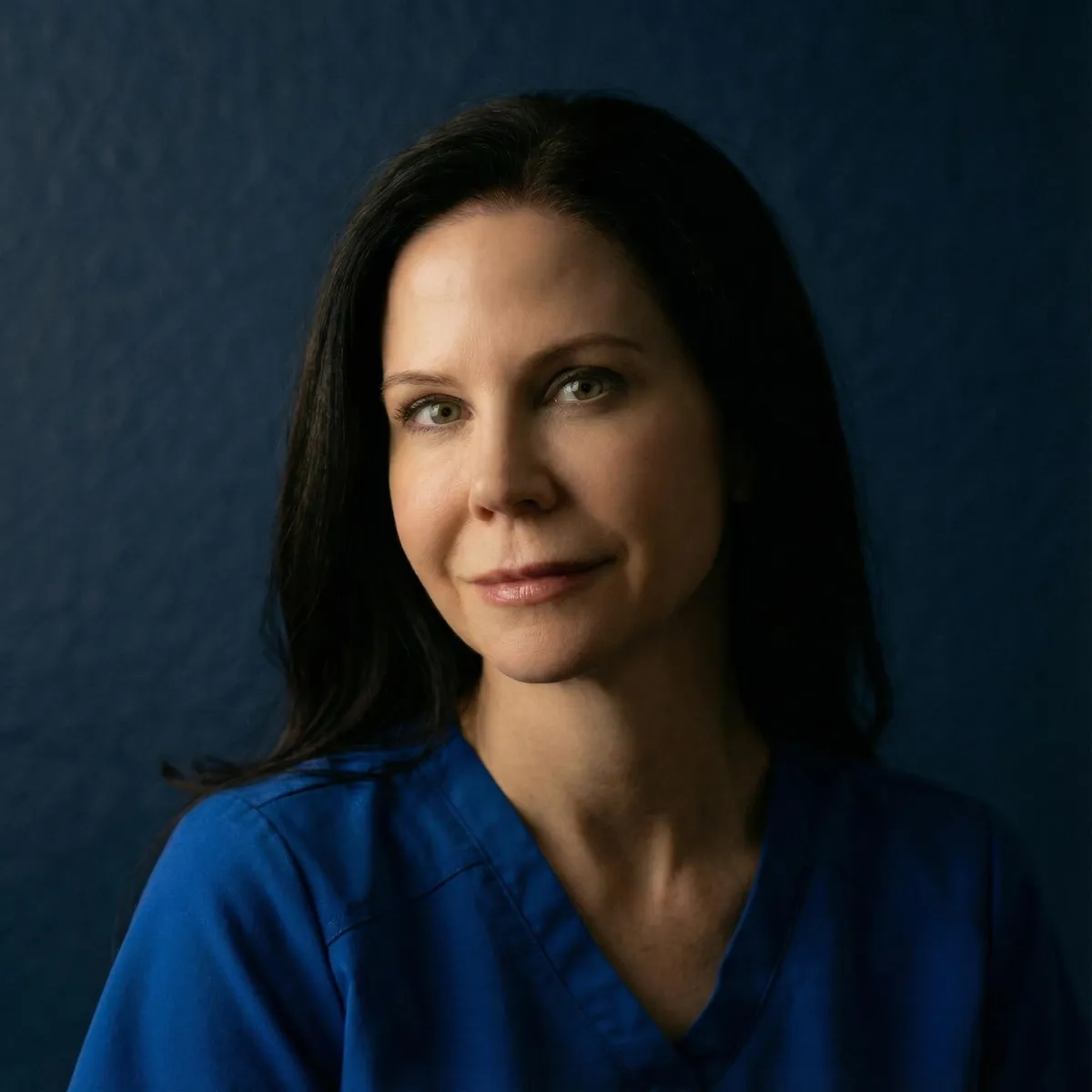 Headshot of Jodi Millsap in natural light, soft smile, neutral backdrop.