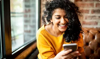 Smiling woman looking at her smartphone