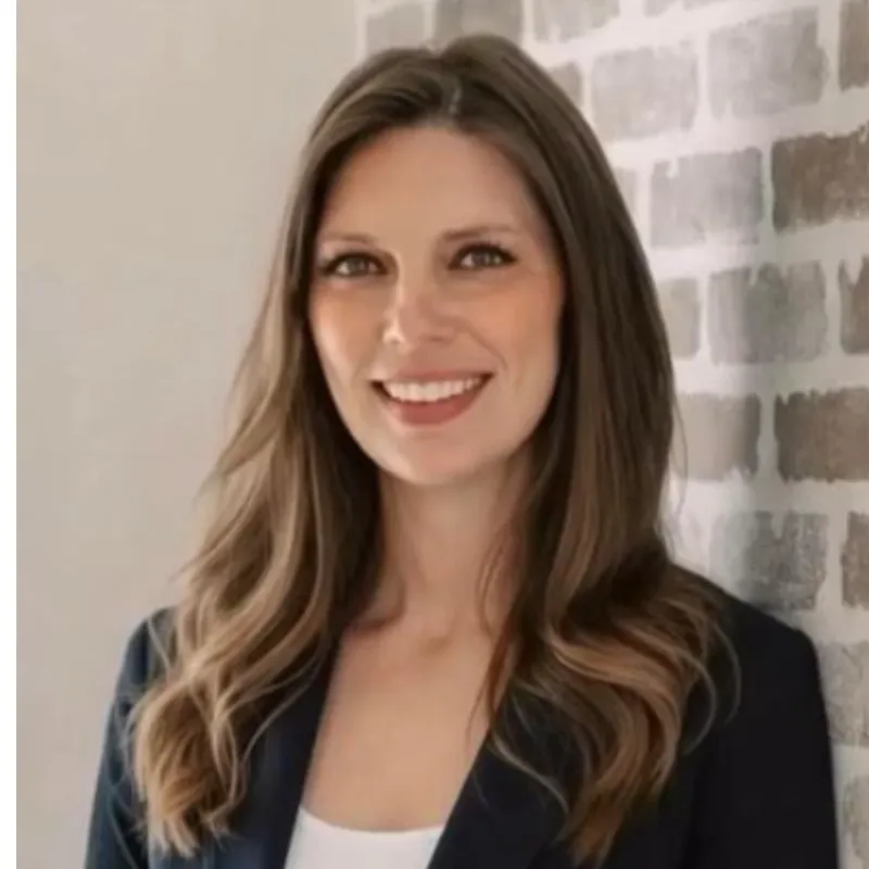 Loan specialist speaking with a client over a laptop at a modern desk