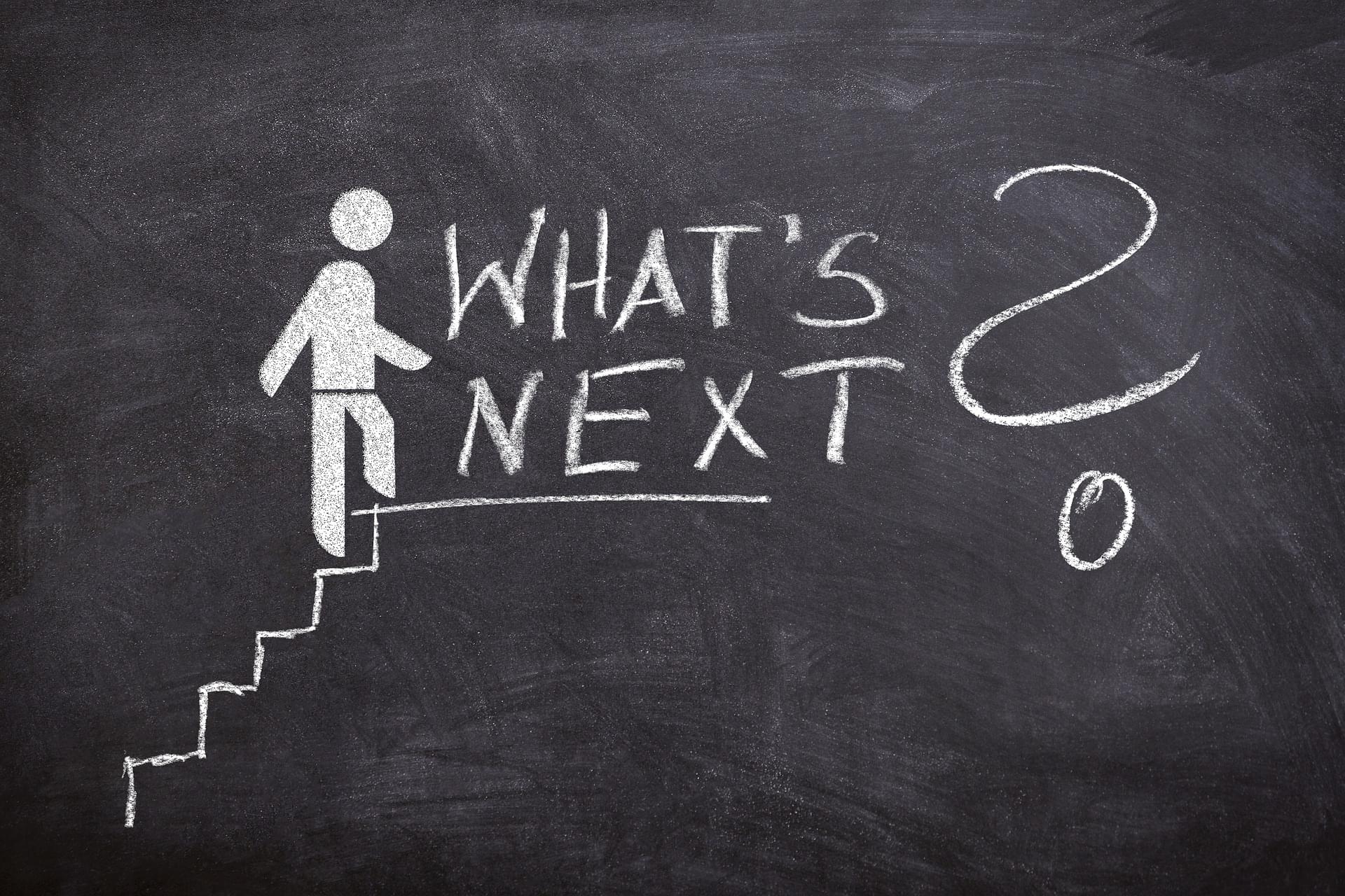 Photo of a chalkboard with a stickperson walking up a stairway, at the top of the stairway are the words “What’s Next?” to indicate that Ask The Resume Lady's career coaching can help engineers plan their career transition