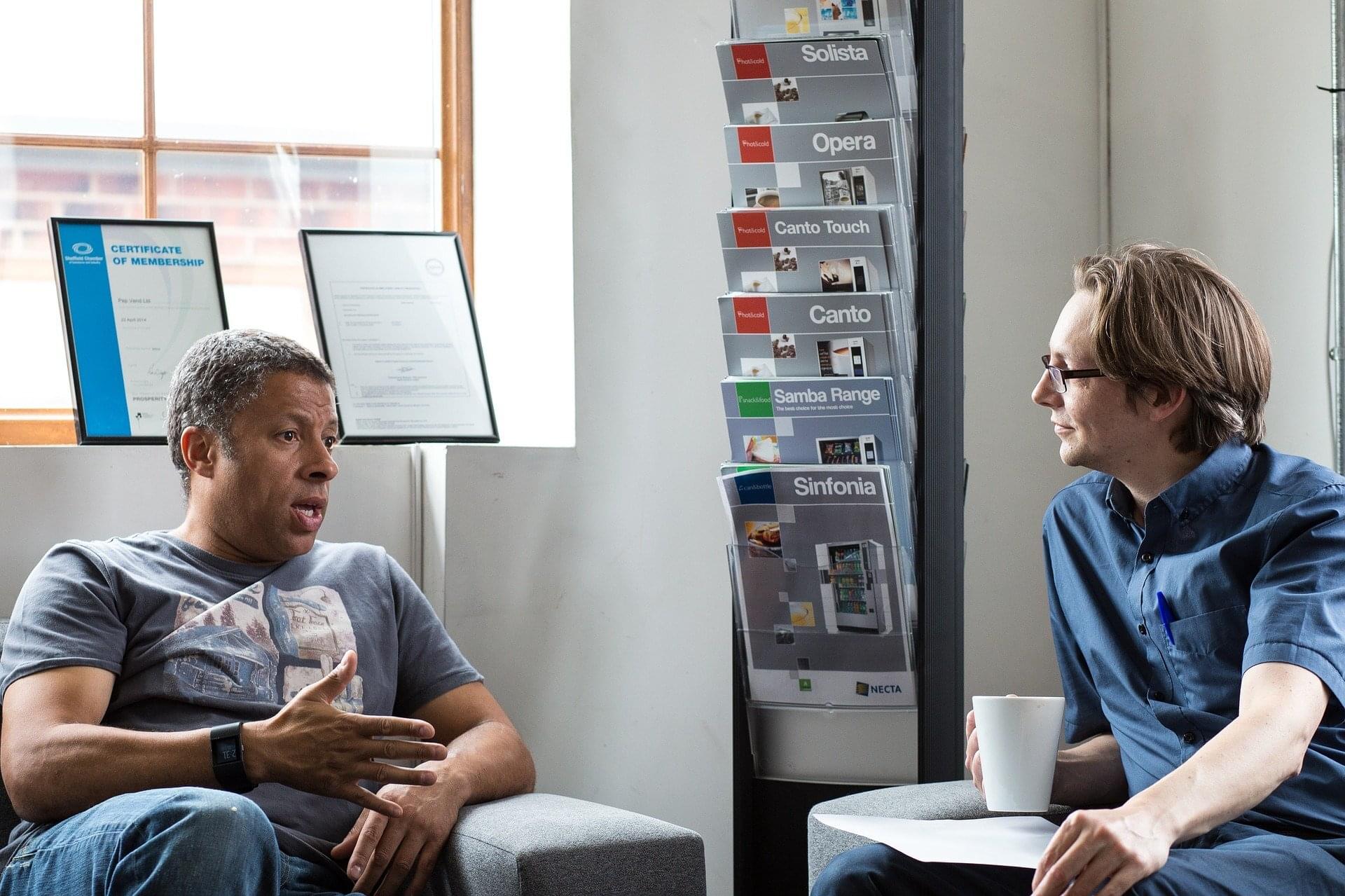 Photo of 2 people talking to indicate that Ask The Resume Lady helps engineers develop their elevator pitches