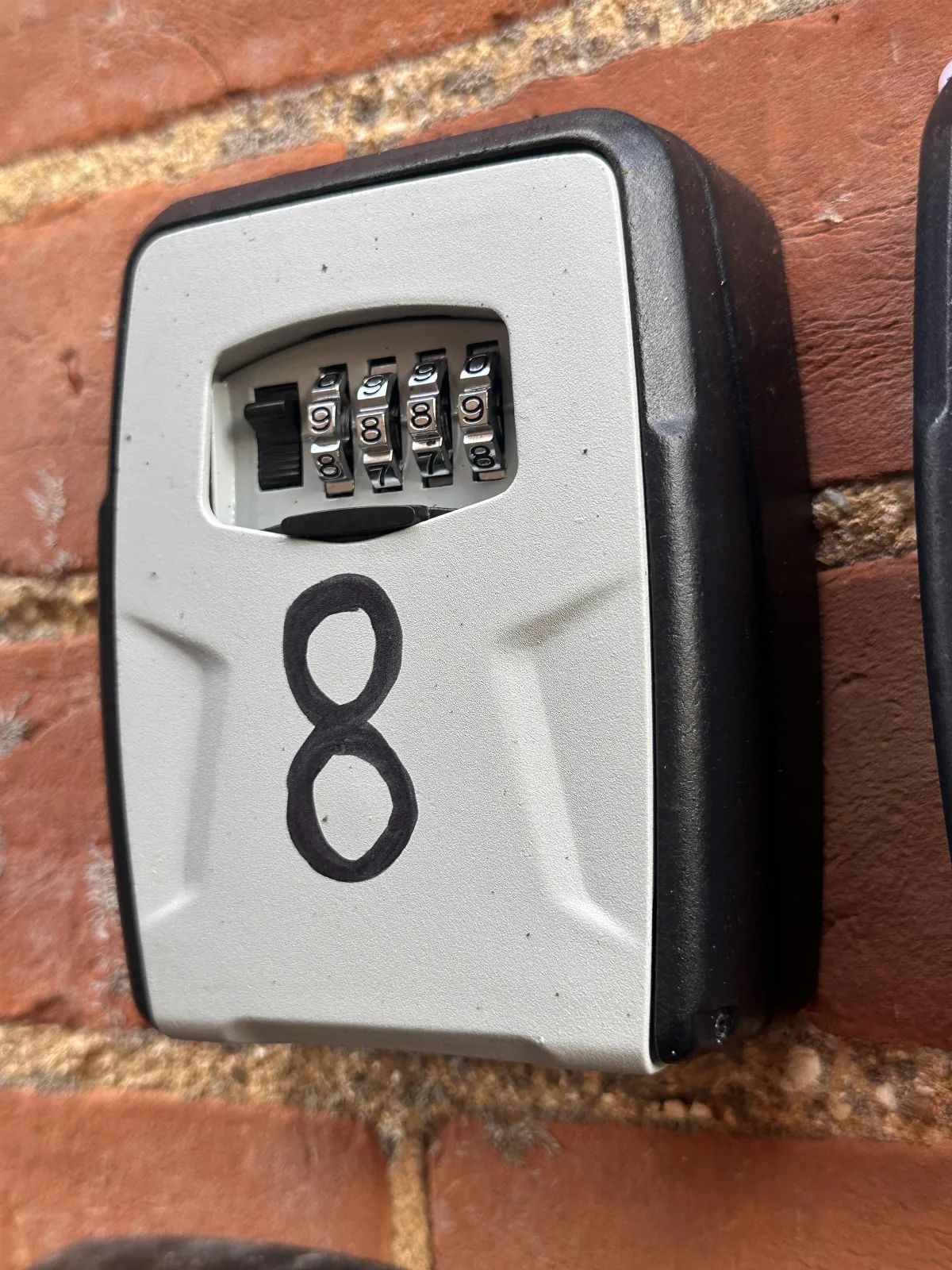 A combination lock-box containing a customer's car key