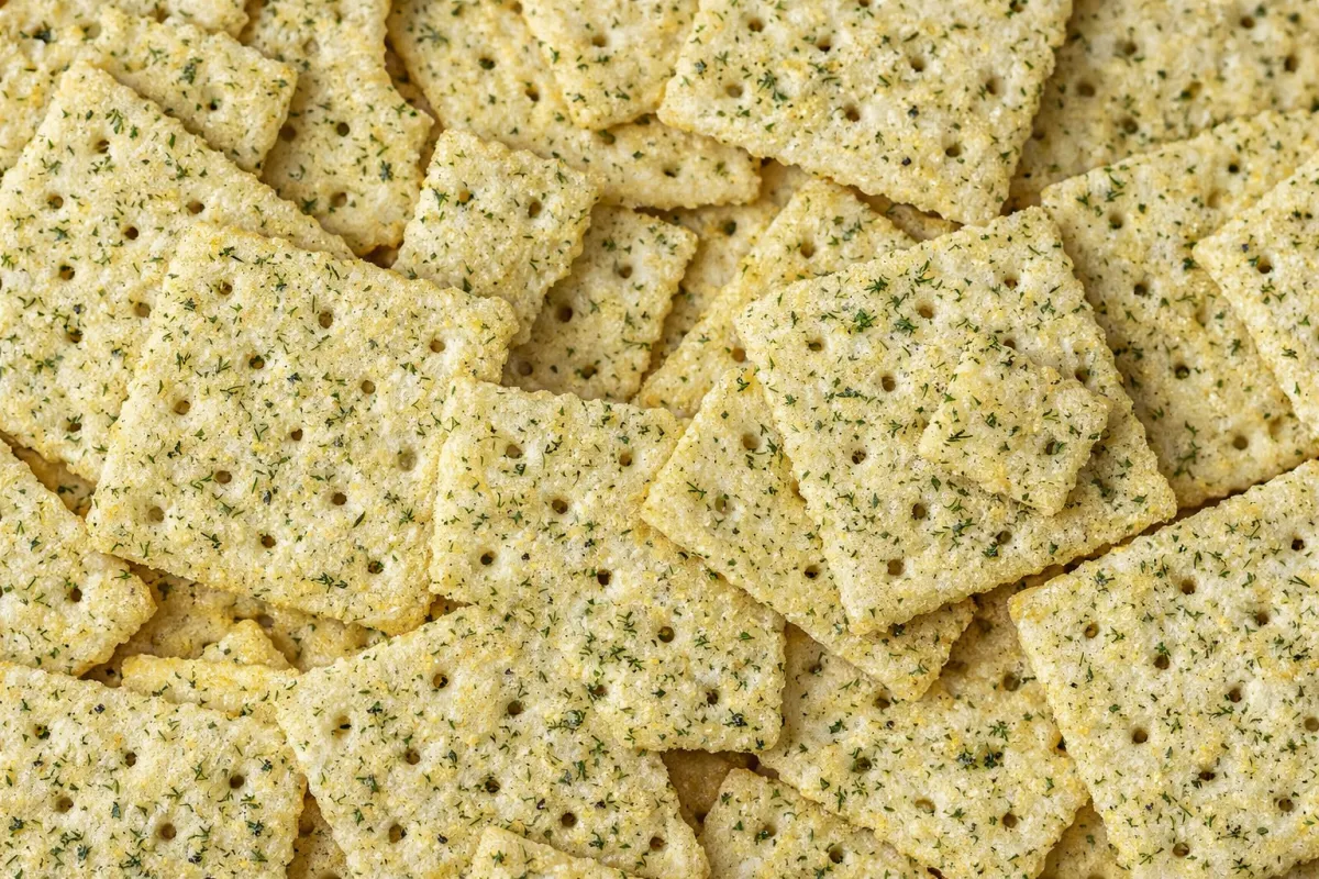 a pink bowl filled with cashews on a yellow background