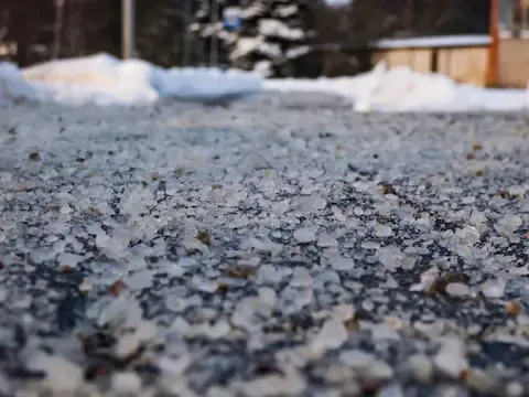 Ice melt and salt spread across driveway for deicing service in Danbury