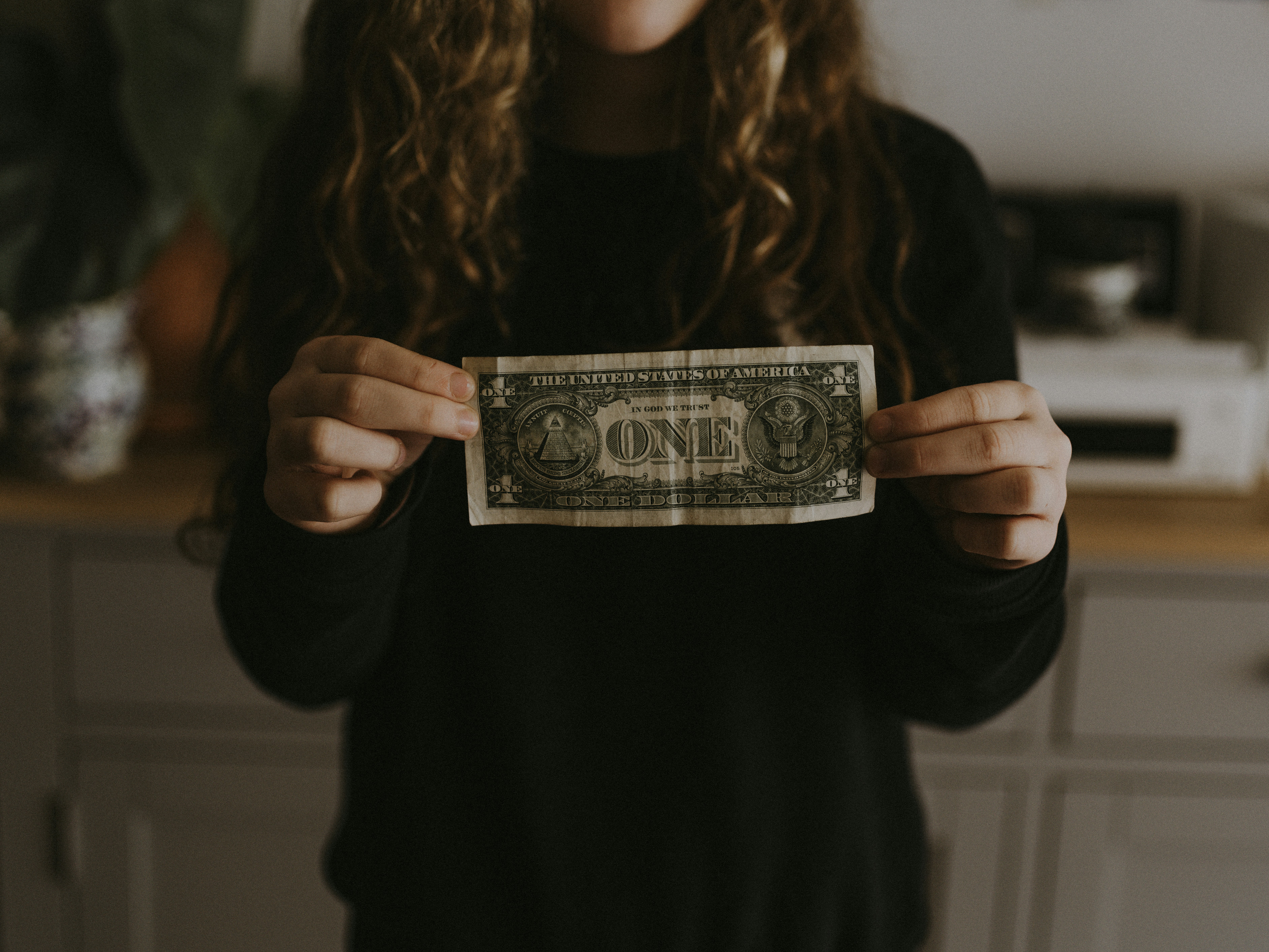 Mom holding a dollar