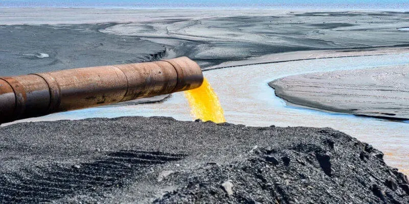 Vertido industrial contaminando una fuente de agua en Nueva Jersey, ilustrando el riesgo de desechos tóxicos que afectan la salud y calidad del agua potable.