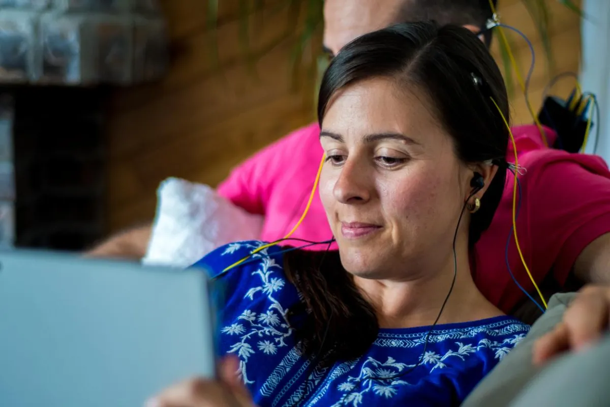 A woman and her husband enjoy an at home neurofeedback session 
