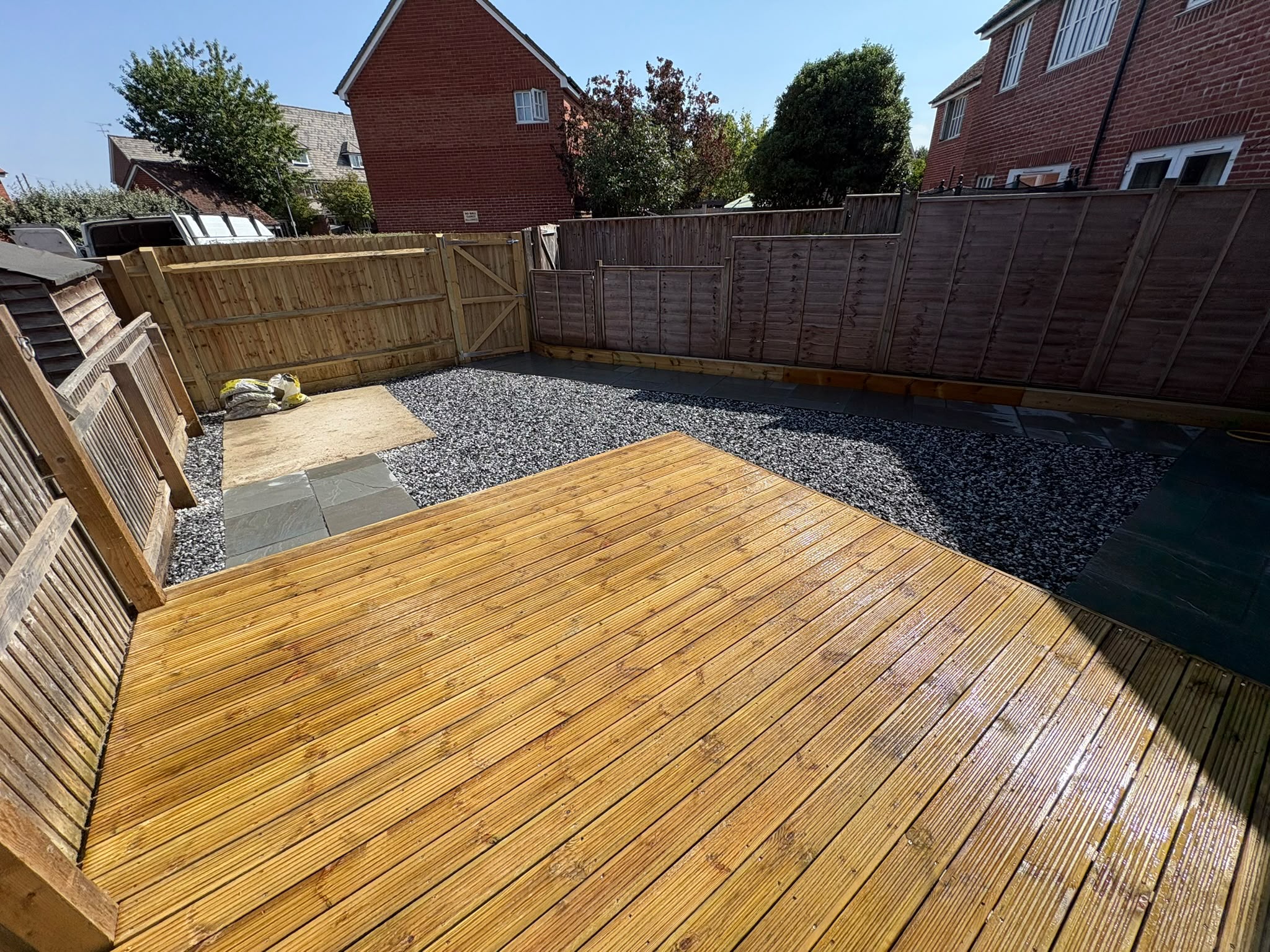 Landscaper in Alton laying new turf in a back garden