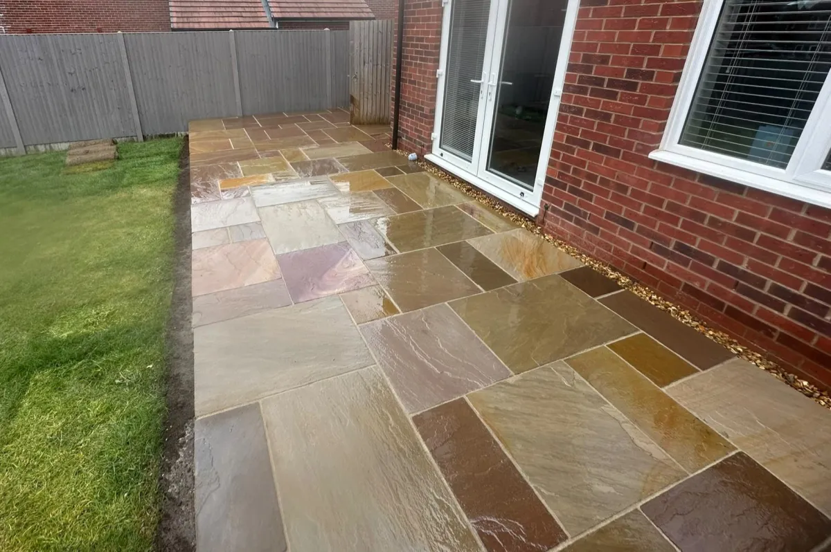 Paving contractor in Alton laying a new patio with grey slabs