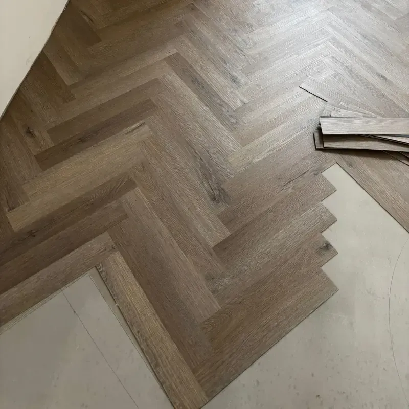 Herringbone luxury vinyl tile floor installation in progress by Cornwall Floorcare