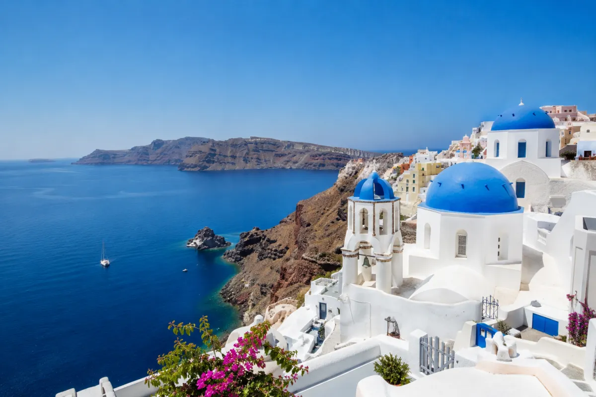 Santorini coastline with white buildings, blue domes, and ocean views for a destination travel guide
