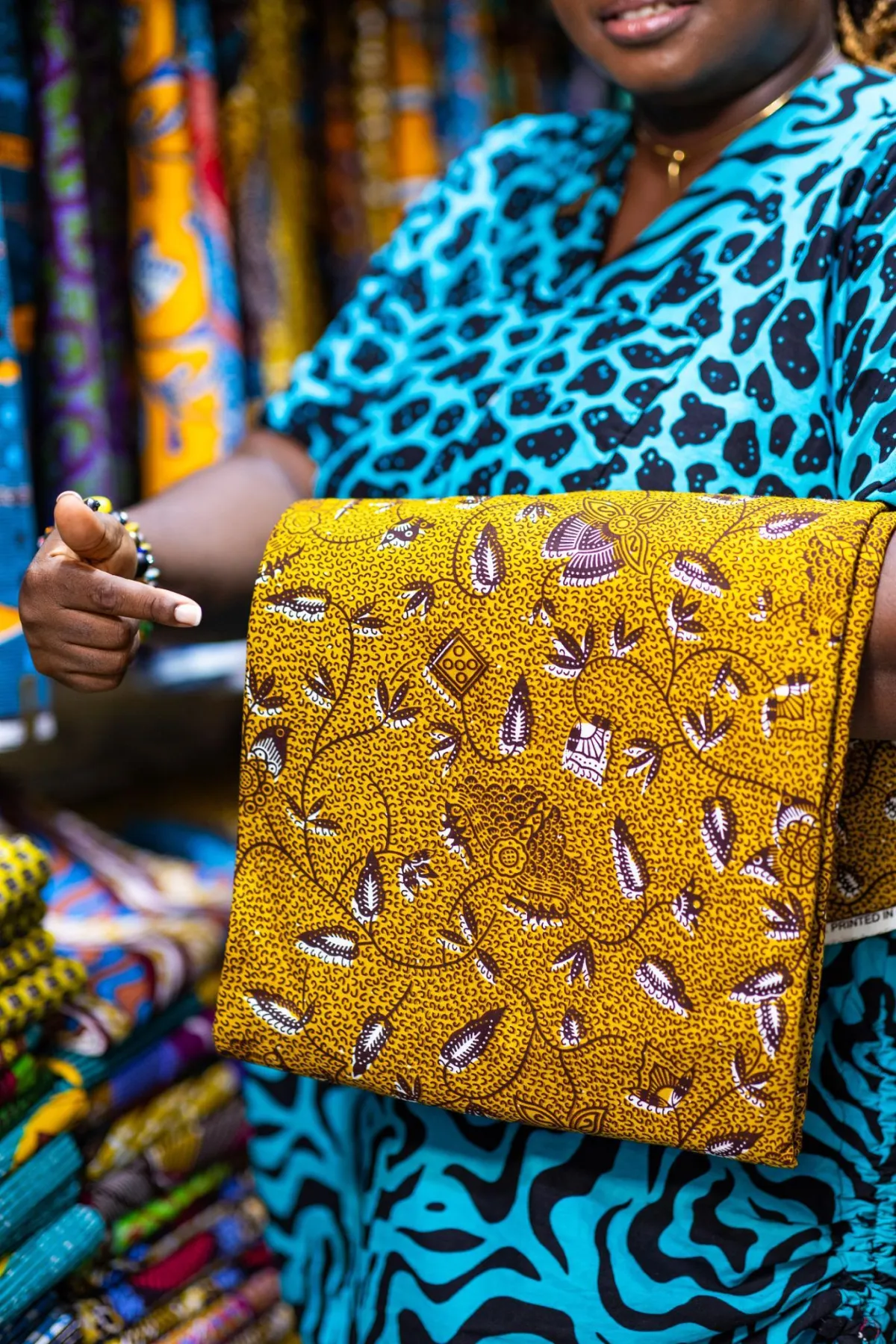 Portrait of a senior barber consulting a client with sample hairstyle book open, soft studio lighting, full-length portrait oriented to emphasize professional service and trust.