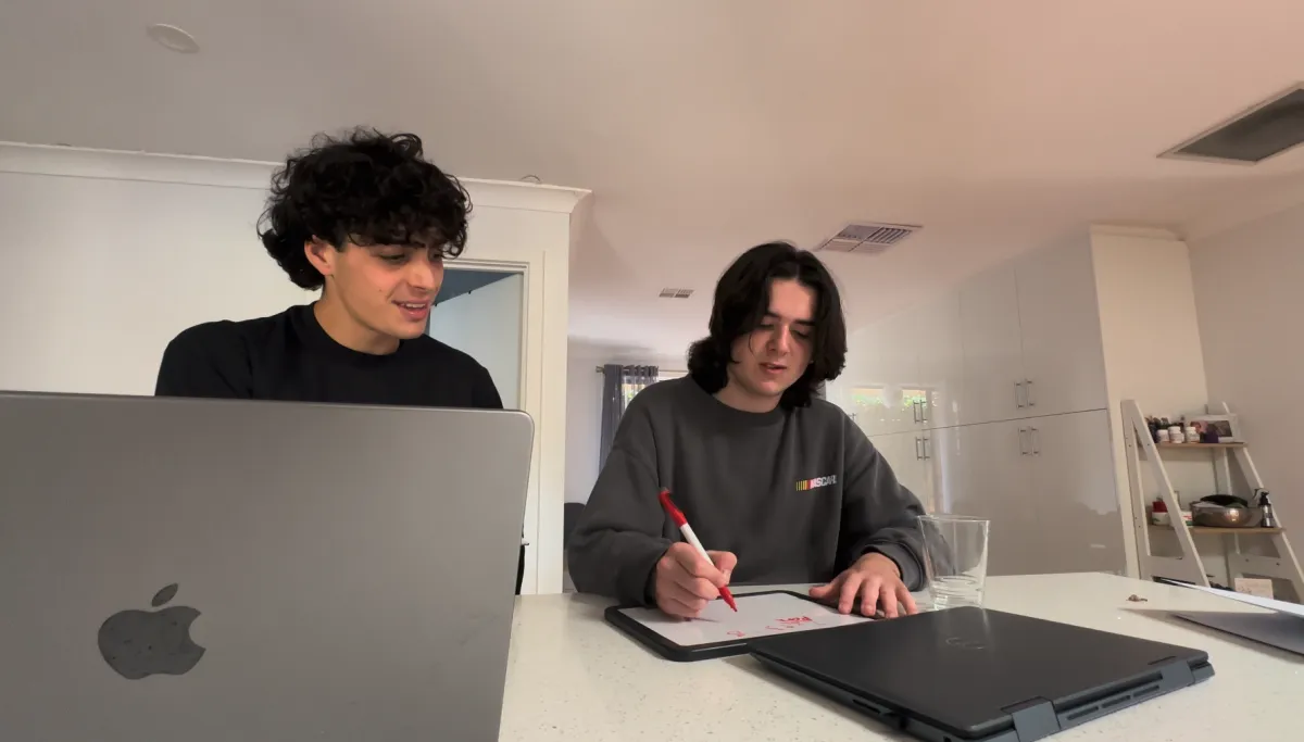 Dedicated private tutor helping a middle school maths student at the kitchen table