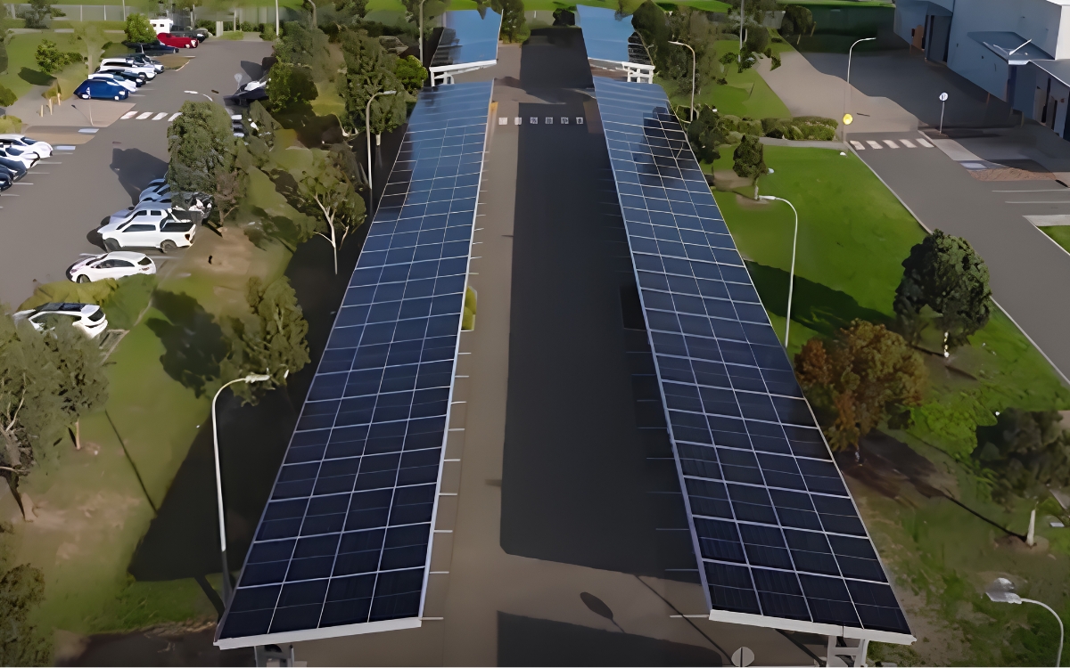 Aerial view of EnharComm's 350 kW rooftop and carport solar installation at RACV, showing rows of solar panels mounted over commercial parking bays.