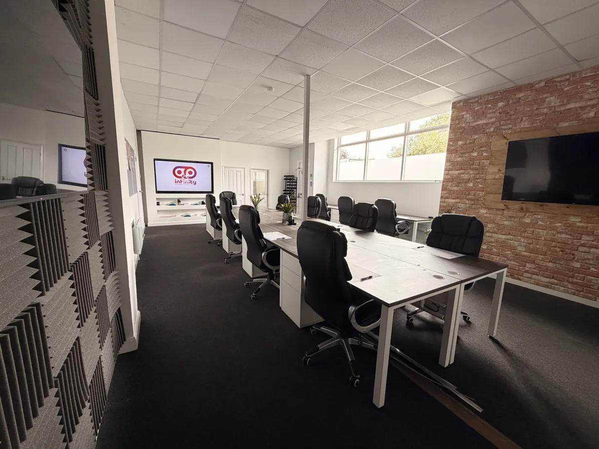 People working productively in the modern Infinity HQ business and training space