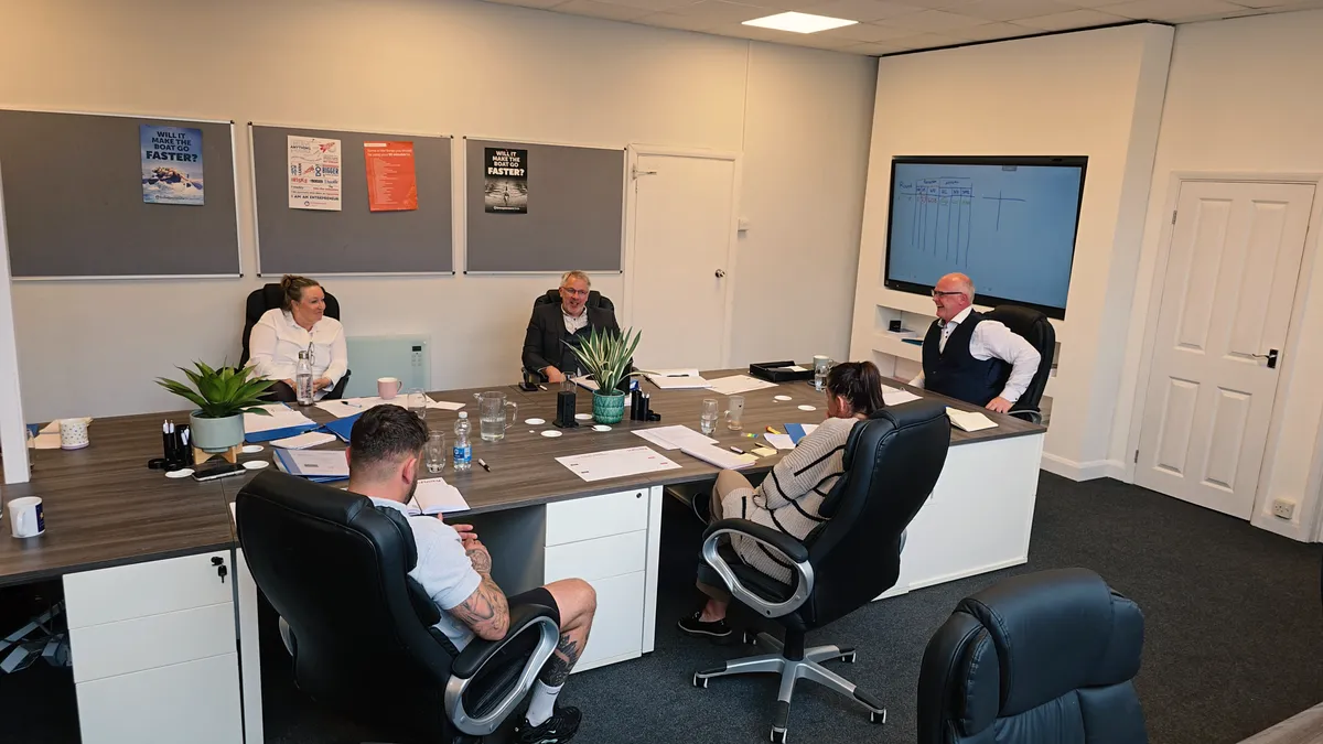 Business owners engaged in supportive discussion around a table