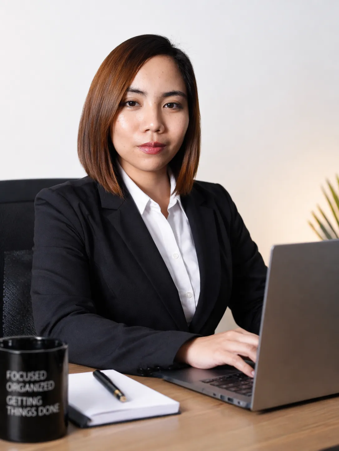 Portrait of Executive Virtual Assistant Melvy Sullano in a bright, neutral workspace