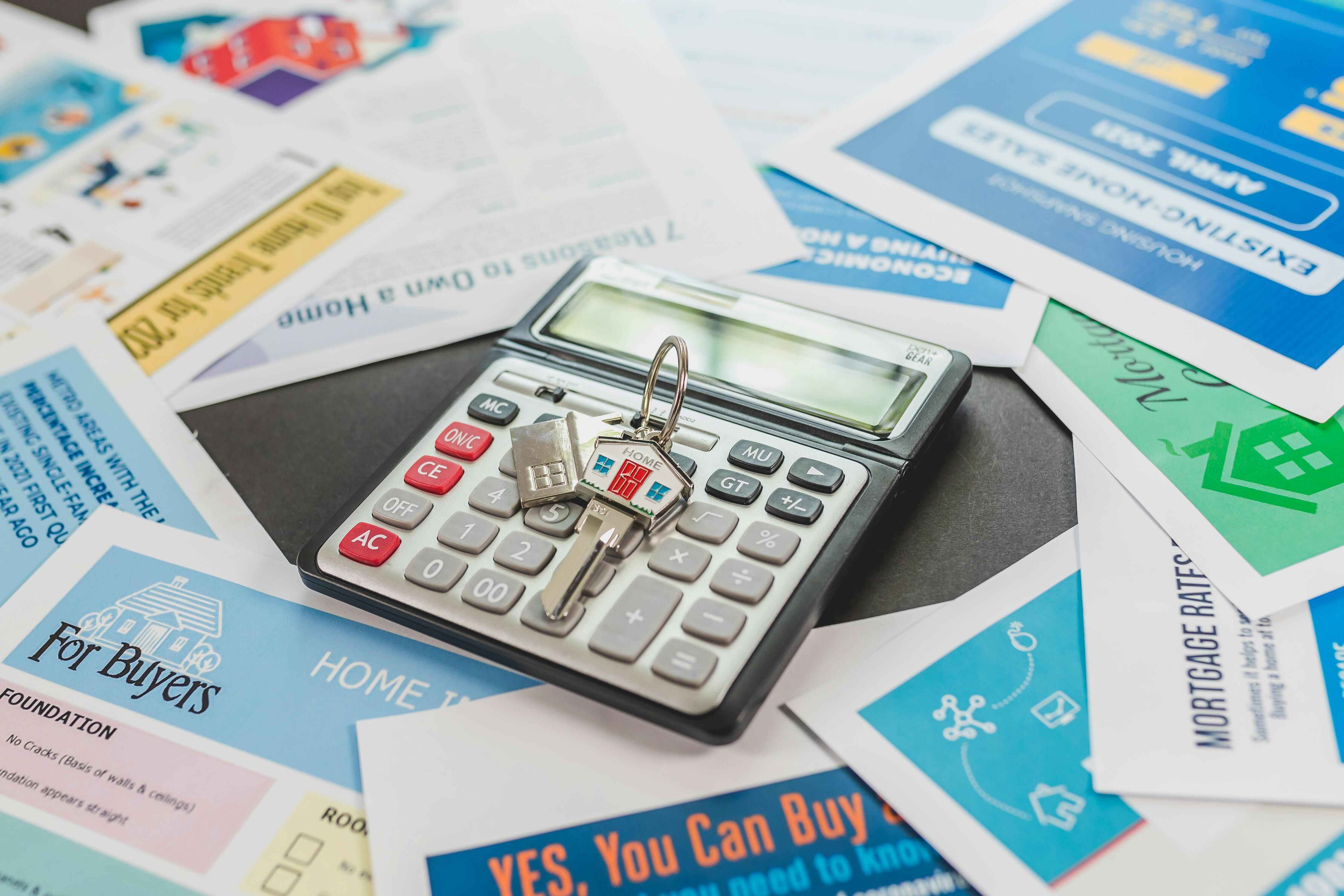 Calculator and house keys resting on property research documents as Wollongong buyers assess their options following the federal budget 2026