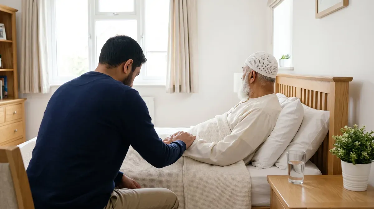 A son at his elderly father's bedside, his right hand on his father's hand, making dua for shifa