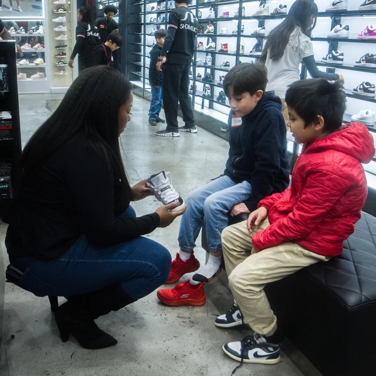 two person wearing white and black Nike shoes