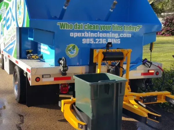Steam-cleaning trash bins on an Apex Bin Cleaning truck