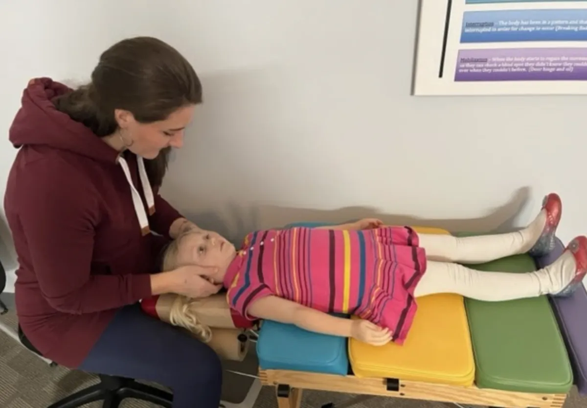 Doctor gently adjusting a child